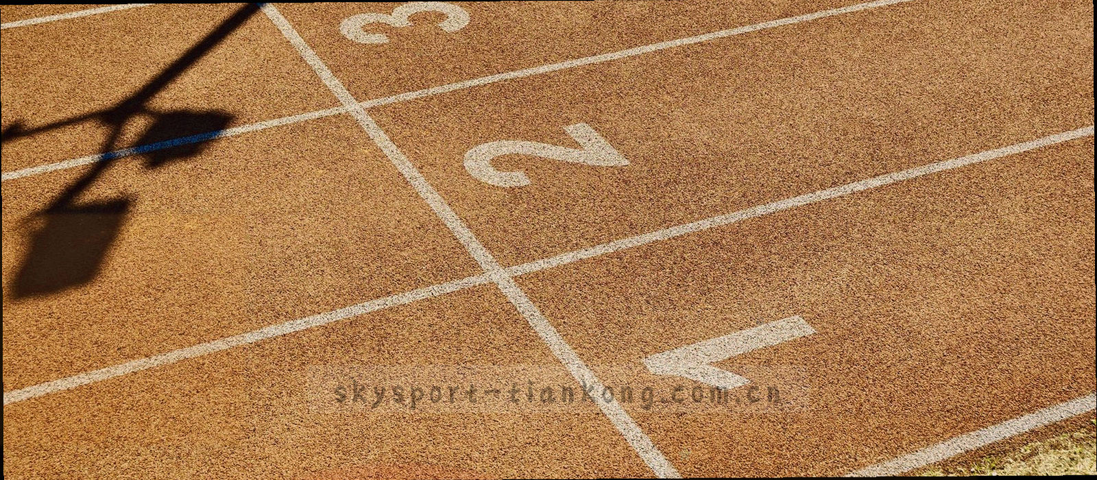 夜幕下亮灯球场的长曝光画面，冷蓝底色上叠着暖色灯光